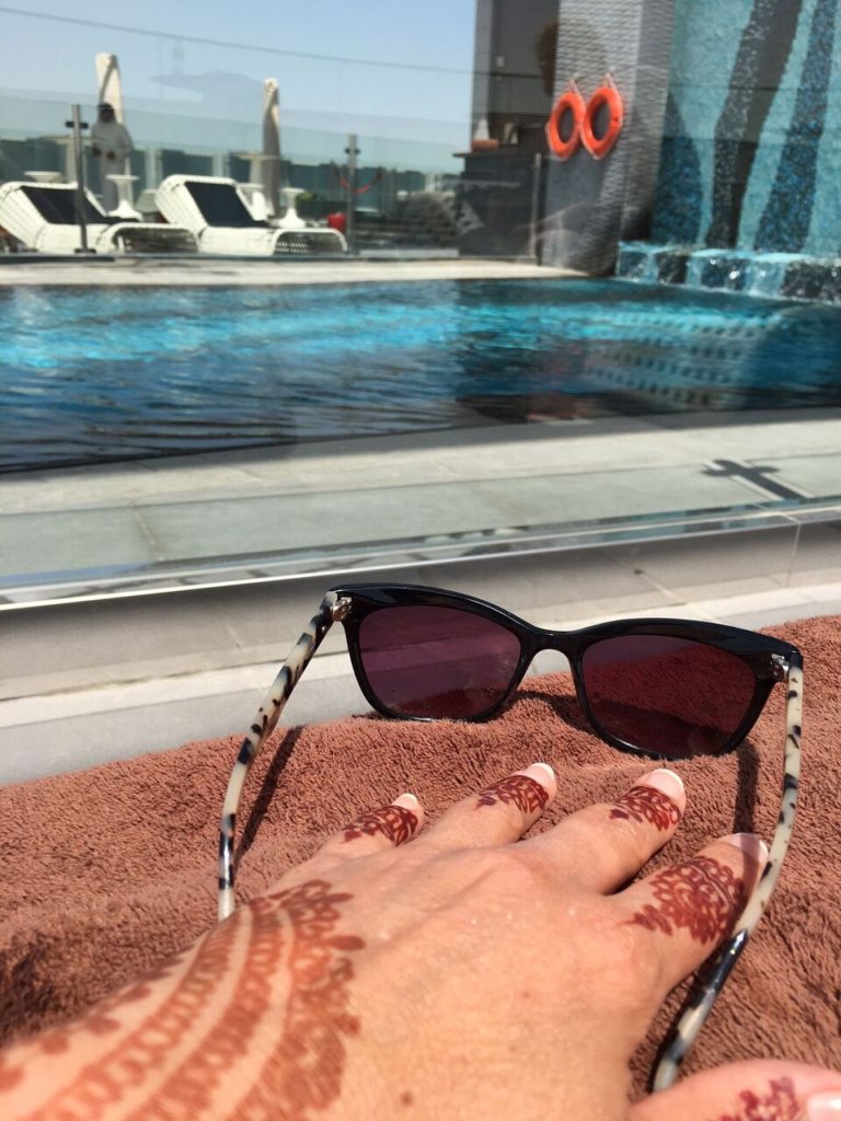 Relaxing by the pool in Doha.