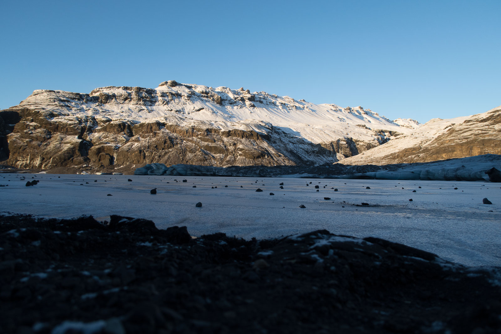 The frozen landscape and mountainous backdrop in Iceland.