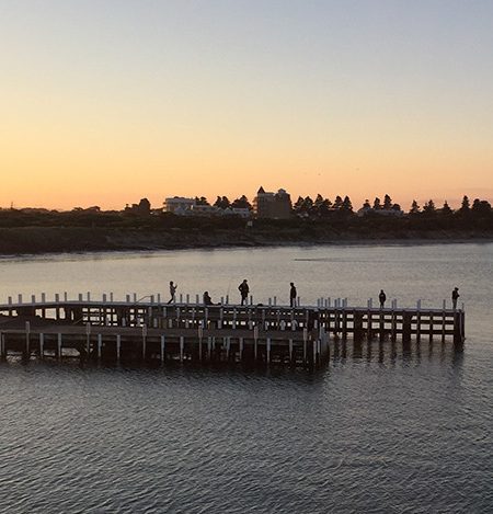 The pier and calm waters of Lady Bay in Warrnambool at sunset.