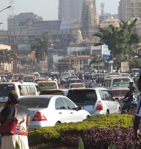 Pedestrians, bikes and cars jostle for position in the packed streets of Kampala, Uganda.