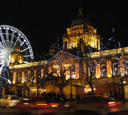 Night view of the giant wheel and Town Hall in Belfast.