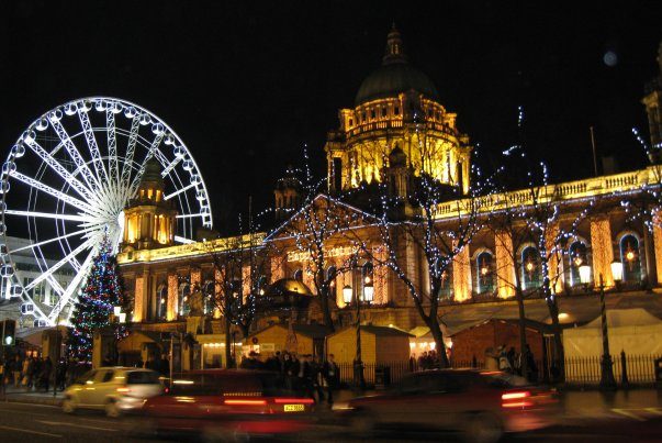 Night view of the giant wheel and Town Hall in Belfast.